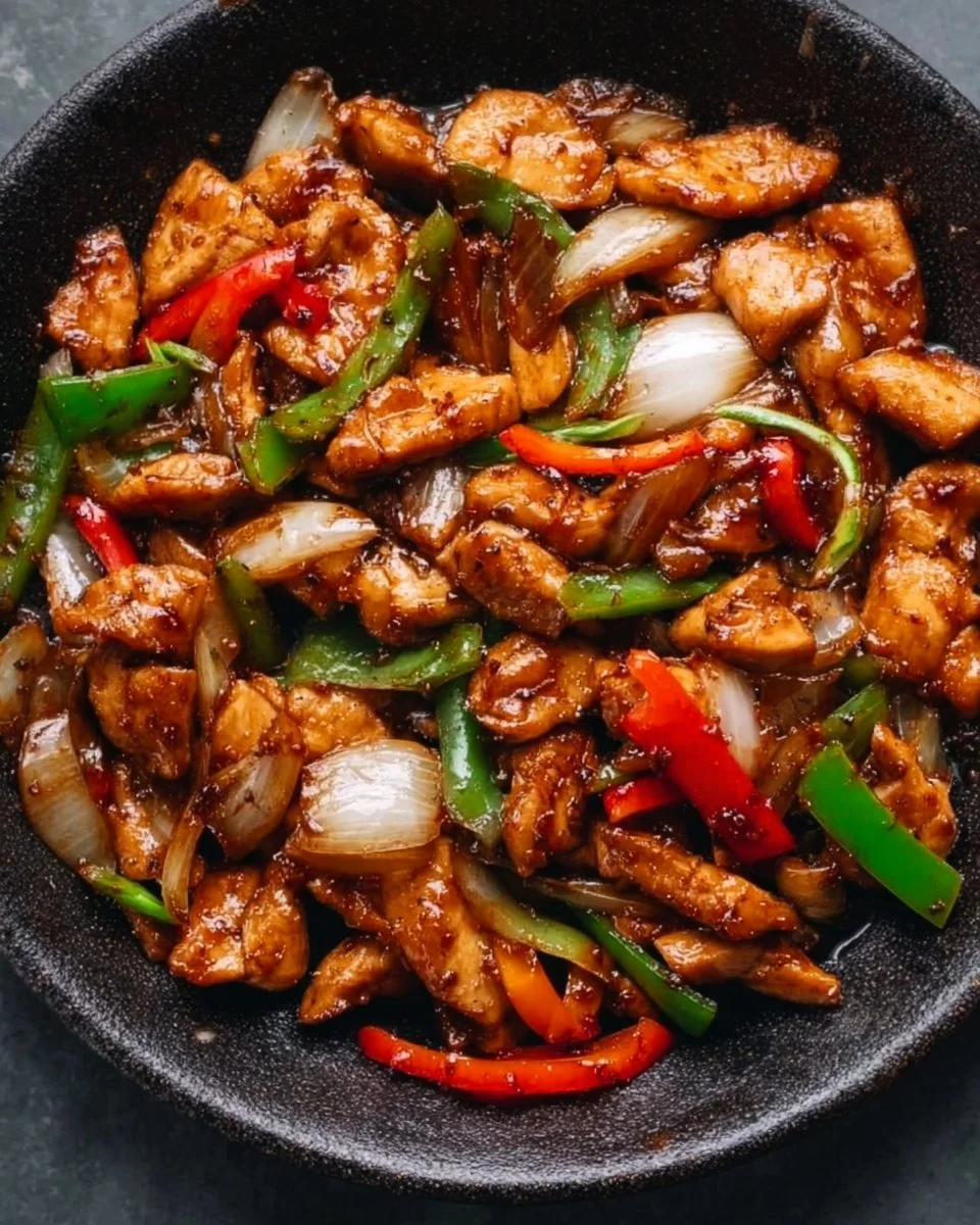 Delicious black pepper chicken served on a plate with vegetables