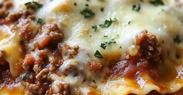 Delicious Crockpot Ravioli Lasagna served in a bowl with layers of pasta and cheese.
