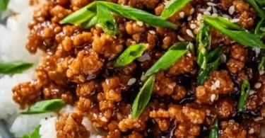 Honey garlic ground turkey served in a bowl with fresh vegetables and rice