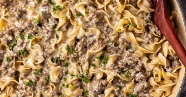 Creamy ground beef stroganoff served with noodles in a bowl