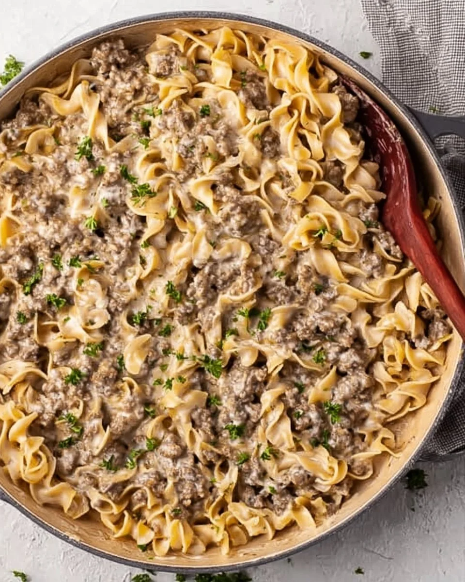 Creamy ground beef stroganoff served with noodles in a bowl