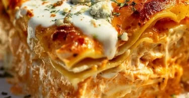 Delicious Cheesy Buffalo Ranch Chicken Lasagna topped with cheese and ranch dressing