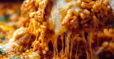 Delicious Chicken Enchilada Rice Casserole topped with cheese and cilantro.