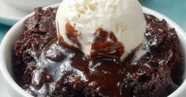 Homemade Crockpot Brownies Pudding served in a bowl with chocolate drizzles