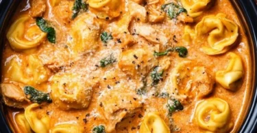 CrockPot Chicken Tortellini dish served in a bowl with herbs and garnish