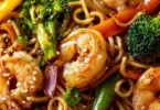 High-protein shrimp stir fry in a skillet with colorful vegetables