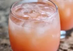 Iced Guava White Tea Lemonade in a glass with lemon garnish