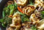 Delicious quick potsticker stir fry with colorful vegetables in a pan.