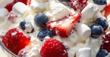 Red White and Blue Cheesecake Salad with fresh strawberries, blueberries, and creamy cheesecake topping