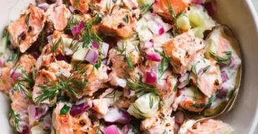 Colorful and fresh salmon salad with vegetables and dressing