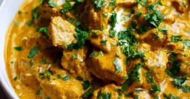 Slow cooker chicken korma with spices and creamy sauce in a bowl