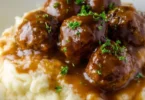 Slow Cooker Salisbury Steak Meatballs served on a plate with gravy