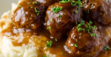 Slow Cooker Salisbury Steak Meatballs served on a plate with gravy
