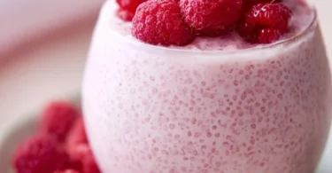 Vanilla Raspberry Chia Pudding topped with fresh raspberries and mint leaves